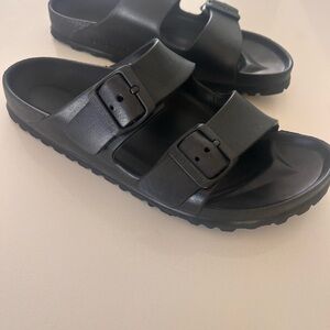 Birkenstock black rubber sandals.